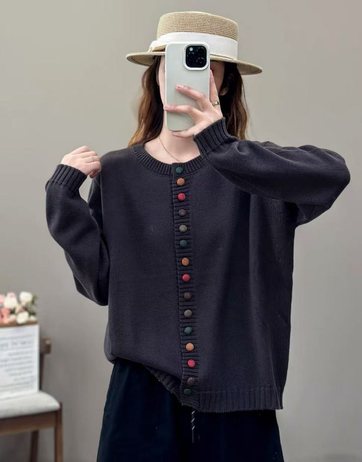 woman wearing a dark sweater with colorful buttons against a plain background.
women’s knit sweater, sleek pullover, casual knit top, lightweight sweater, everyday women’s pullover, soft knit sweater, stylish women’s sweater, versatile knitwear, comfortable pullover, modern women’s sweater

